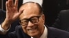 Hong Kong's richest man Li Ka-shing, 89, waves as he leaves a press conference in Hong Kong on March 16, 2018.