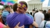 Gay rights supporters celebrate after the U.S. Supreme Court ruled that the U.S. Constitution provides same-sex couples the right to marry, outside the Supreme Court building in Washington, June 26, 2015.