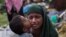 FILE - A Rohingya Muslim child kisses his mother as they rest after having crossed over from Myanmar to the Bangladesh side of the border near Cox's Bazar's Teknaf area, Sept. 2, 2017. Tens of thousands of others crossed into Bangladesh in a 24-hour span as they fled violence in western Myanmar, the UNHCR said. 