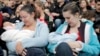 FILE - Mothers feed their babies in Paris, Oct. 11, 2008, during a worldwide breastfeeding event. 