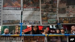 人们在香港阅读关于静坐示威民众和警察冲突的新闻报道（2014年9月29日）