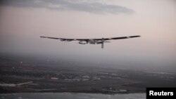 FILE - The Solar Impulse 2 airplane, flown by test pilot Markus Scherdel, flies off the coast of Oahu during a test flight from Kalaealoa Airfield in Kapolei, Hawaii, March 3, 2016.