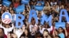 Supporters hold signs as U.S. President Barack Obama speaks during a campaign event at Canyon Springs High School in Las Vegas, Nevada, August 22, 2012. 