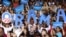 Supporters hold signs as U.S. President Barack Obama speaks during a campaign event at Canyon Springs High School in Las Vegas, Nevada, August 22, 2012. 