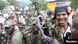 Congolese Revolution Army [M23] rebels sit on a truck soon after capturing the city from the government army, as they patrol a street in Goma in the eastern Democratic Republic of Congo, November 20, 2012.
