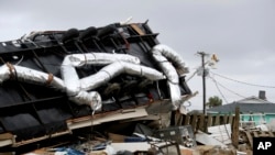 Power company linemen work to restore power after a tornado hit Emerald Isle, N.C. as Hurricane Dorian moved up the East coast, Sept. 5, 2019.