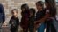 Children form a line as undocumented immigrant families are released from detention at a bus depot in McAllen, Texas, June 22, 2018. Experts say being separated from their parents can take a heavy toll on children.