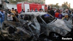 5月15日，伊拉克首都巴格達以北薩德爾城發生汽車爆炸後，公眾爆炸現場圍看。