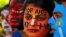 FILE - Students with their faces painted with messages pose during an HIV/AIDS awareness campaign to mark the International AIDS Candlelight Memorial, in Chandigarh, India, May 20, 2018. 