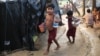 Rohingya children walk to their tents after fetching drinking water at a makeshift camp near Kutupalong refugee camp in Cox's Bazar, Bangladesh, Tuesday, Oct. 3, 2017. More than half a million Rohingya have fled from Myanmar to Bangladesh in just over a month, the largest refugee crisis to hit Asia in decades.