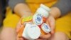 FILE - A woman holds a handful of her medication bottles at the Altoona Center for Clinical Research in Altoona, Pennsylvania, March 29, 2017, where she was helping test an experimental non-opioid pain medication.