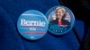 FILE - A demonstrator wears Democratic presidential candidate's Sen. Bernie Sanders, I-Vt., and Hillary Clinton buttons during a rally in New York, March 31, 2016.