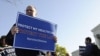 Health care law proponents (L) walk past opponents from the Tea Party Patriots group (R) on the sidewalk outside ongoing legal arguments over the Patient Protection and Affordable Care Act at the Supreme Court in Washington, March 26, 2012. 