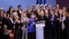 Far-right leader presidential candidate Marine Le Pen, center, stands among party officials at the end of a conference in Lyon, France, Sunday, Feb. 5, 2017.