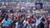 A man holds up a painted portrait of Edward Lowassa, former prime minister of Tanzania and presidential candidate for UKAWA, a coalition of four main opposition parties, during a political rally in Dar es Salaam, Tanzania, Aug. 29, 2015.