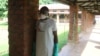 A health worker prepares to take off protective clothing after visiting the isolation ward at Bikoro hospital, which received a new suspected Ebola case, in Bikoro, Democratic Republic of Congo, May 12, 2018. 