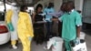 FILE - A health worker sprays a colleague with disinfectant during a training session for Congolese health workers to deal with Ebola virus in Kinshasa, Oct. 21, 2014. The Democratic Republic of Congo had declared a two-month ebola outbreak over.
