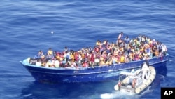 2015年8月22日意大利海军图片: 意大利海军小艇接近装满移民的船只