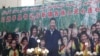 FILE - A propaganda poster showing Chinese President Xi Jinping with ethnic minority children and the slogan which reads "Party Secretary Xi Jinping and Xinjiang's multi ethnic residents united heart to heart" decorates the side of a building in Kashgar, 