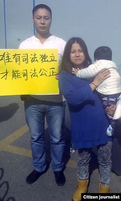 深圳警官王登朝由于宣传民主理念而被以经济罪名判刑，他妻子李彦婷怀抱尚未见过父亲的幼子与声援者在二审法庭外。 （网友提供）