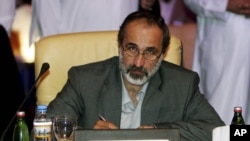 Maath al-Khatib poses for a photo after being elected president of the newly formed Syrian National Coalition for Opposition and Revolutionary Forces, created after the Syrian National Council (SNC) agreed to the new group, November 11, 2012.