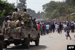 FILE - Oromo regional police officers wait in a pick up car during the Oromo new year holiday Irreechaa in Bishoftu, Ethiopia, Oct. 2, 2016.