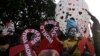 Participants hold placards in the shape of the red ribbon, the universal symbol of awareness and support for those living with HIV, as a hot air balloon is released during an awareness campaign ahead of World AIDS Day in Kolkata, India, Nov. 30, 2018.