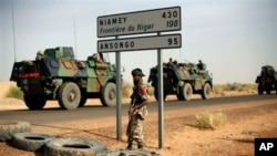 French armored vehicles are seen heading towards the Niger border before making a left turn north in Gao, northern Mali, Feb. 6, 2013