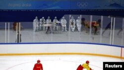 身穿防護服的中國醫護人員在觀看中國冰球隊練習。 （2022年1月29日）