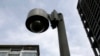 FILE - A surveillance camera is seen near a building.