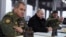 Владимир Путин и министр обороны России Сергей Шойгу (слева) 