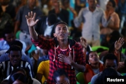 A man attends a prayer session at Biftu Bole Lutheran Church during a prayer and candle ceremony for protesters who died in the town of Bishoftu, in Addis Ababa, Ethiopia, Oct. 16, 2016.