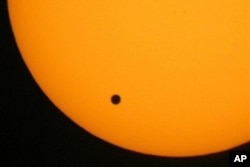 This June 2004 photo shows the transit of Venus, which occurs when Venus passes between the Earth and the sun.