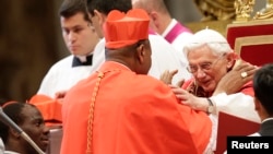 Pope Benedict XVI greets new Cardinal John Olorunfemi Onaiyekan of Nigeria during a consistory ceremony in Saint Peter's Basilica at the Vatican November 24, 2012.