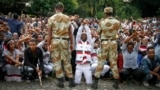 FILE - Ethiopian soldiers try to stop protesters in Bishoftu, during a declared state of emergency, in the Oromia region of Ethiopia, Oct. 2, 2016.