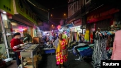 A girl watches as Saen Dao, an eight-year-old female asian elephant, and her mahout perform underwater during a show at the Khao Kheow Open Zoo in Chonburi south of Bangkok.