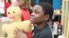 Jacob Leggette shows off the "Tender Hugs" bear he built with the help of a donated 3-D printer. (Courtesy: Digital Harbor Foundation)