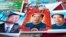 FILE - In this Feb. 5, 2015 file photo, vendors sell posters of Chinese President Xi Jinping, left, and Communist Party founder Mao Zedong, center and right, on a street of Gujiao in northern China's Shanxi province. 