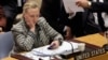 FILE - U.S. Secretary of State Hillary Rodham Clinton checks her mobile phone after her address to the Security Council at United Nations headquarters, March 12, 2012.