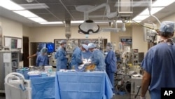 FILE - Doctors perform surgery at St. Vincent Infirmary Medical Center, Little Rock, Arkansas.