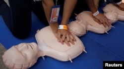 Participants practice cardiopulmonary resuscitation (CPR) during a drill organized by Mexican members of the Red Cross at the Revolution Monument in Mexico City, Mexico, May 7, 2017.