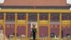 A paramilitary policeman stands guard before a giant portrait of late Chinese Chairman Mao Zedong at the Tiananmen gate, a day before the 19th National Congress of the Communist Party of China begins, in Beijing, China, October 17, 2017. 