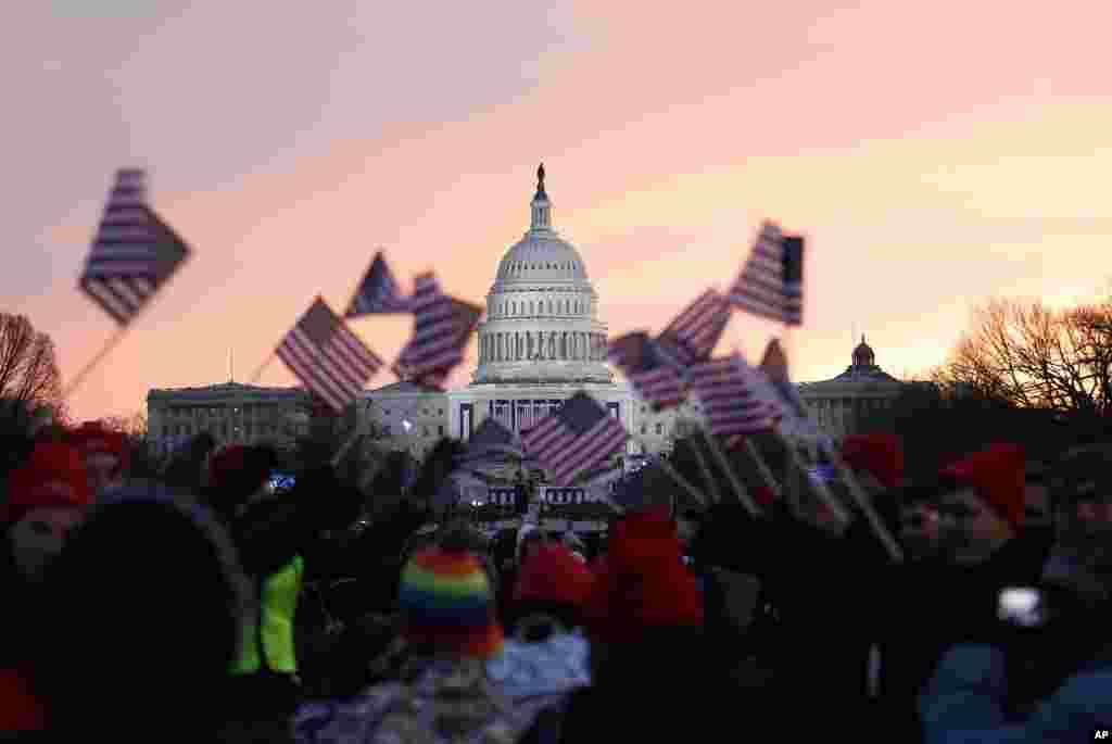 2013年1月21日，奥巴马总统的支持者在总统就职大典开始之前华盛顿的国家大草坪挥舞美国国旗欢庆。