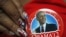 A delegate shows off her Barack Obama button in the convention hall before the Democratic National Convention in Charlotte, North Carolina, Sept. 3, 2012. 