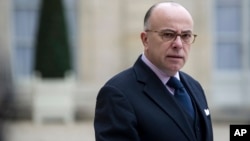 FILE - Then-French Interior minister Bernard Cazeneuve gives a press conference at the Elysee Palace.