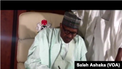 ABUJA: Shugaba Buhari yana sanya hannu kan wasikar sanar da Majalisar Dattawa dawowarsa gida da kuma kama aiki