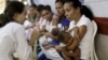 FILE - Mothers with their children, who have microcephaly, await medical care at the Hospital Oswaldo Cruz, in Recife, Brazil, Jan. 26, 2016. 