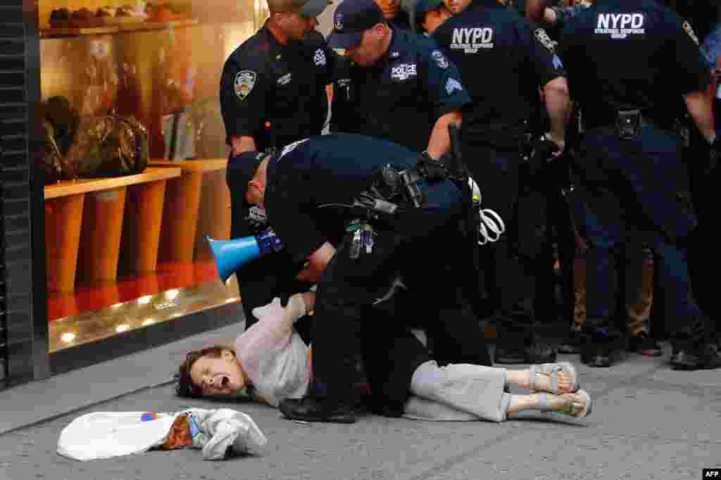 Police arrest a woman near Trump Tower during a protest against U.S. President Donald Trump in New York, Aug. 14, 2017.