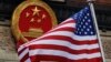 FILE - In this Nov. 9, 2017, file photo, an American flag is flown next to the Chinese national emblem during a welcome ceremony for visiting U.S. China says accusations against an alleged spy of attempting to steal trade secrets from several American avi