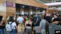 ຜູ້ໂດຍສາຍລຽນແຖວສຳລັບການອອກເດີນທາງຢູ່ສະໜາມບິນ BER Berlin-Brandenburg, ເຢຍຣະມັນ, 19 ກໍລະກົດ 2024.